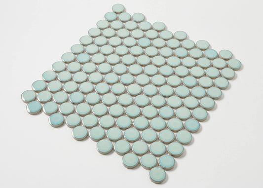 A diamond-shaped mosaic sheet of Antique Green Gloss Glazed Porcelain Penny Round 28mm Diameter tiles displaying a soft mint-green glazed finish arranged in neat circular rows.