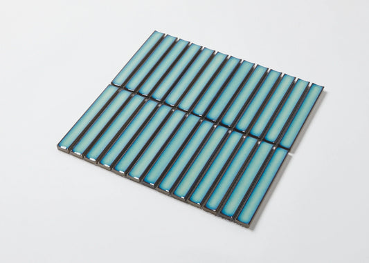 Pack shot of Antique Medium Green Gloss Concave Porcelain Glazed Finger 20x145mm tiles arranged in a flat grid, showcasing their elongated concave profile and blue-green gloss finish.