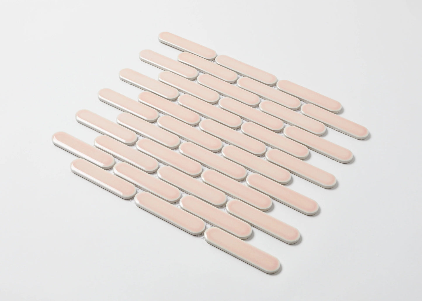 Pack shot of Antique Pink Gloss Round Head Finger Glazed Mosaic 23x93mm tiles arranged in a staggered diagonal pattern with white grout joints on a light background.