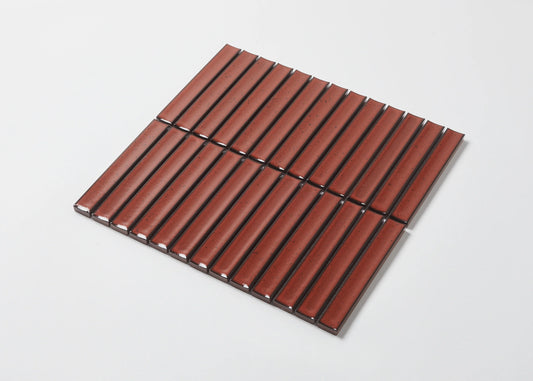 Pack shot of Antique Terracotta Red Speckled Gloss Concave Porcelain Glazed Finger 20x145mm tiles arranged in a flat lay grid showing the ribbed concave surface, warm red speckled glaze, and dark grout lines.