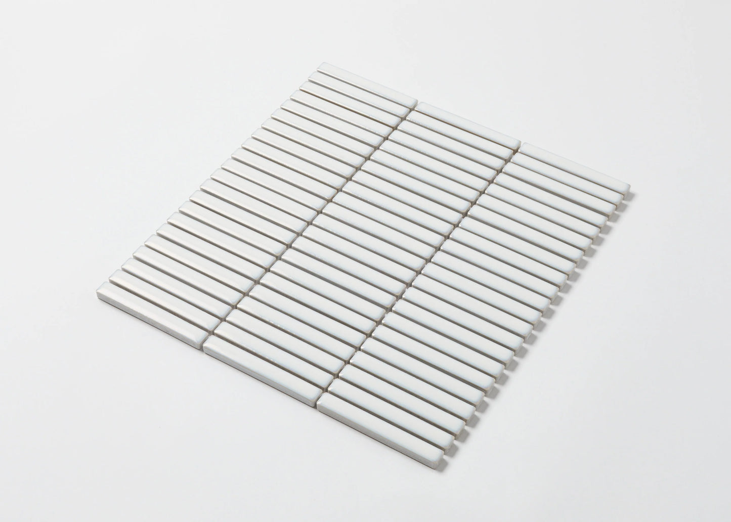 Pack shot of Antique White Gloss Porcelain Glazed KitKat 12x92mm tiles arranged in a flat mosaic sheet showing narrow white glossy finger-shaped strips.