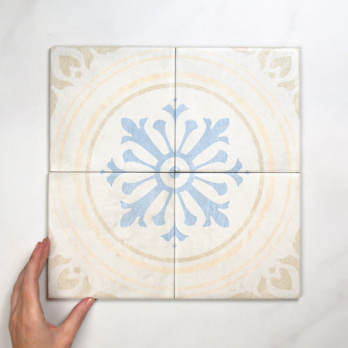 Antiquity Seville Decor 150x150mm top view, hand for scale