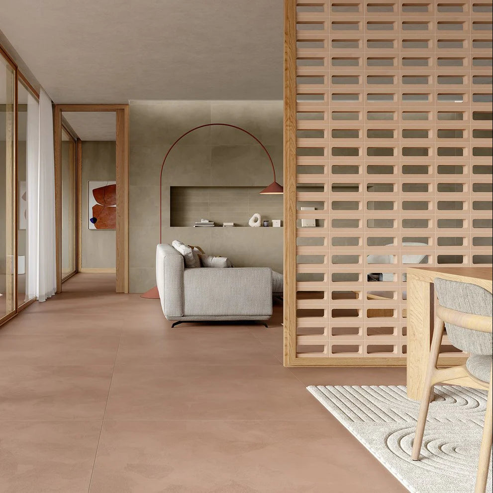 Arialuce Asole Avorio Breeze Blocks 120x240 installed as a slatted room divider partition in a modern open-plan living space with warm terracotta flooring and Scandinavian-style timber chair.