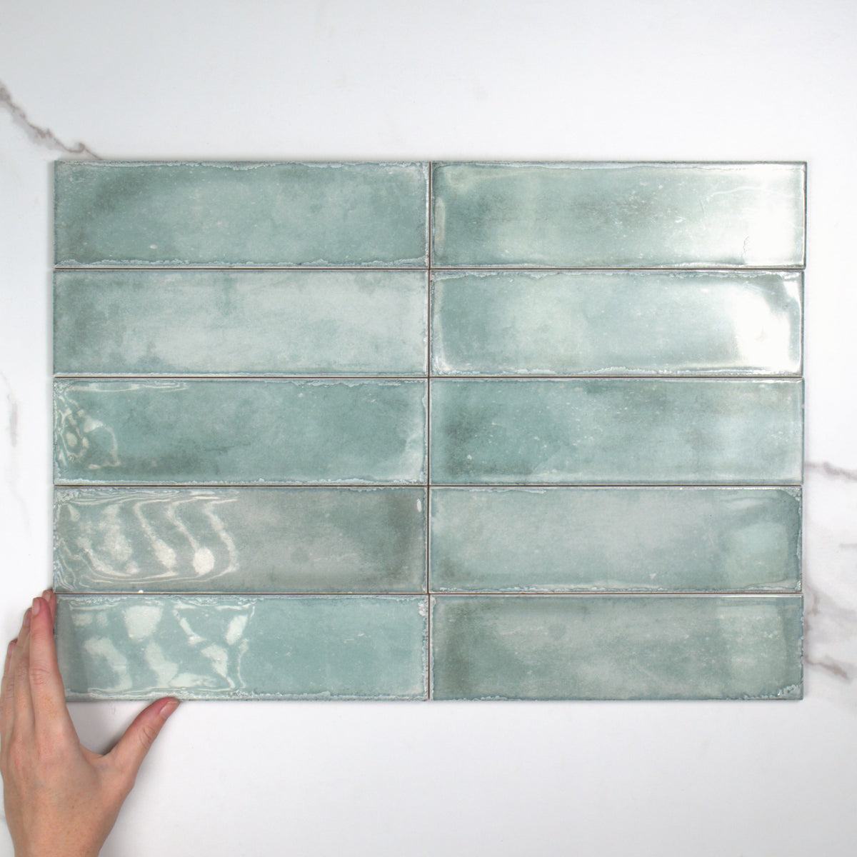 Atlantique Aquamarine Gloss 69x240mm top view, hand for scale