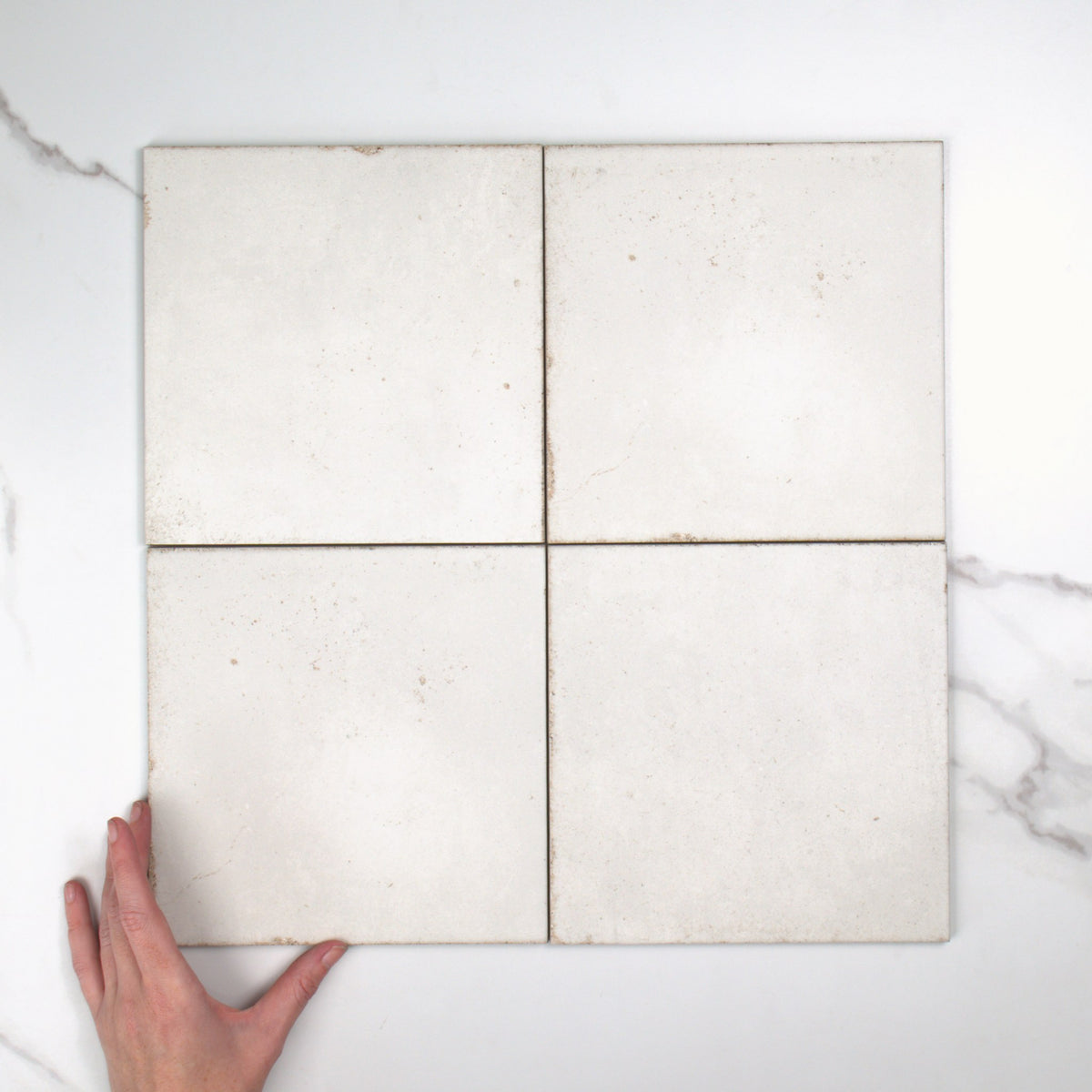Atlantique Blanc Matt 200x200mm top view, hand for scale