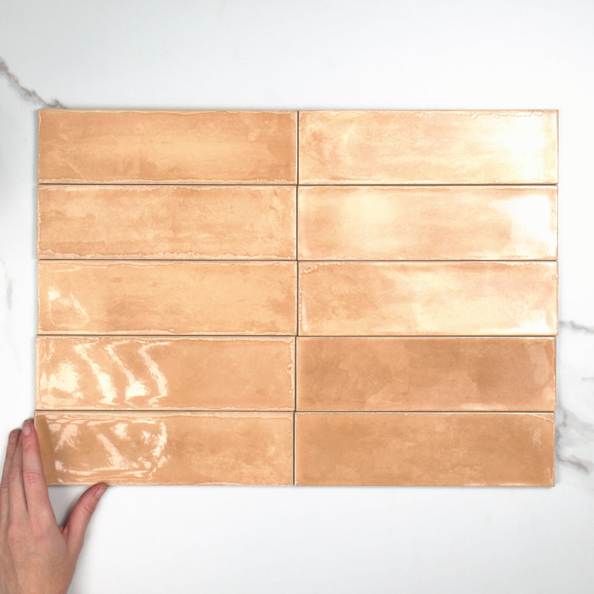 Atlantique Cotto Gloss 69x240mm top view, hand for scale