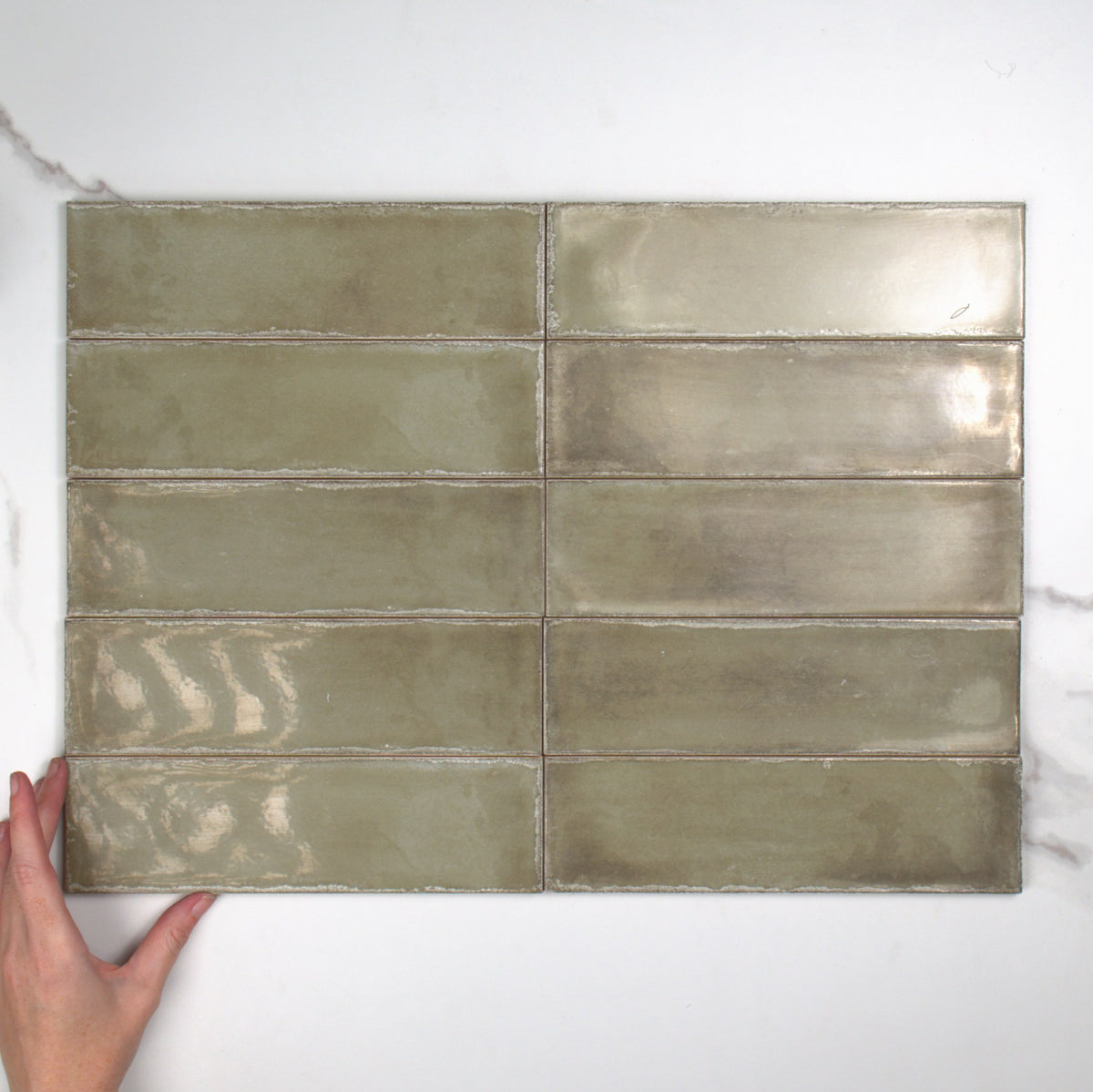 Atlantique Olive Gloss 69x240mm top view, hand for scale