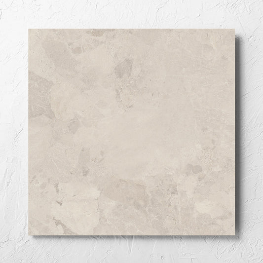 Aurelia Stone Ash Grip 600x600mm tile laid flat on a white rendered wall, showing the matt surface