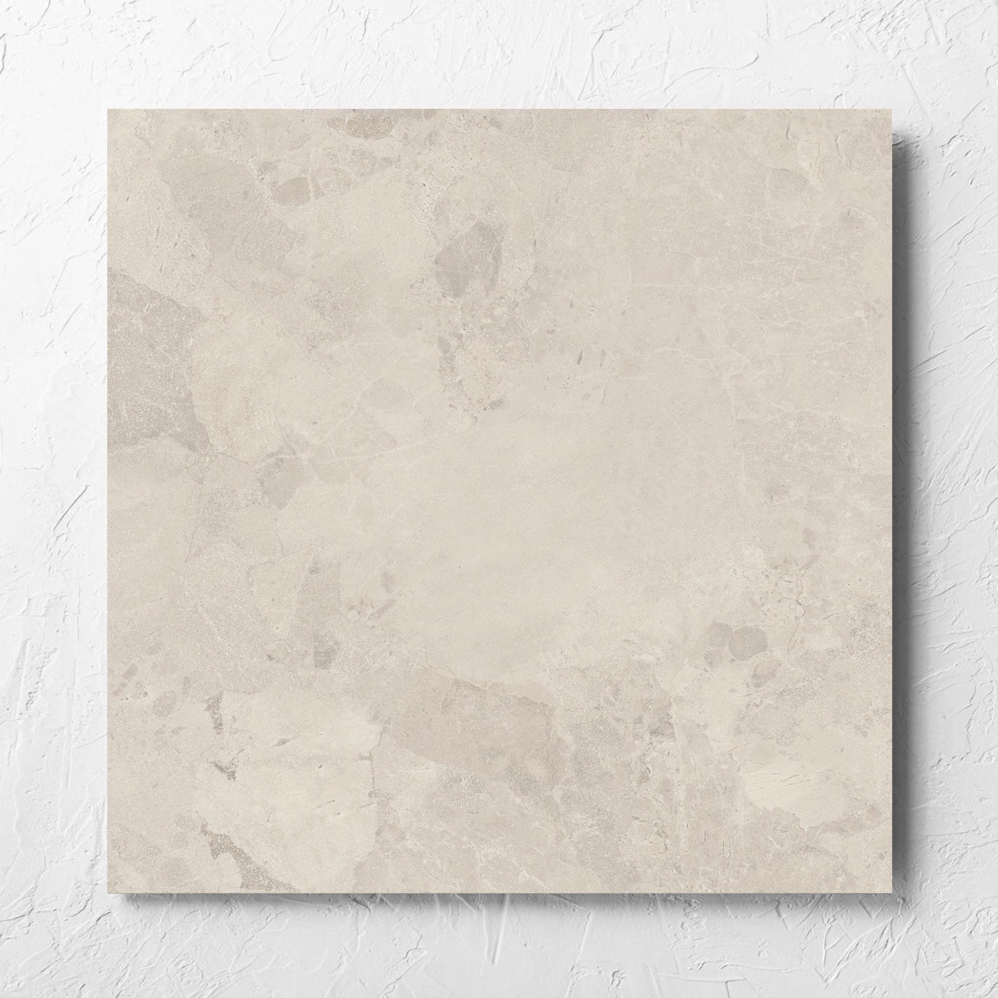 Aurelia Stone Ash Matt 600x600mm tile laid flat on a white rendered wall, showing the matt surface