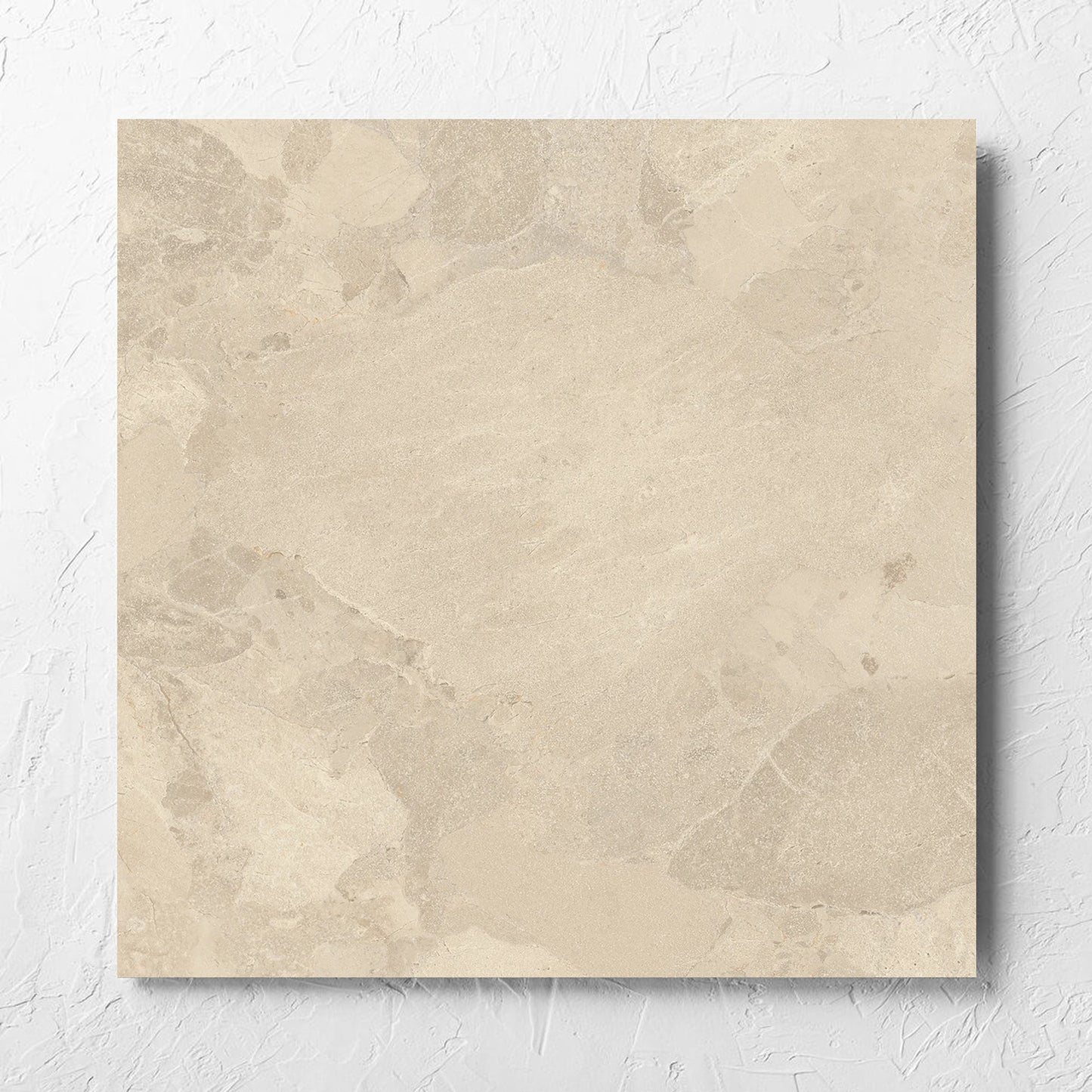 Aurelia Stone Beige Grip 600x600mm tile laid flat on a white rendered wall, showing the matt surface