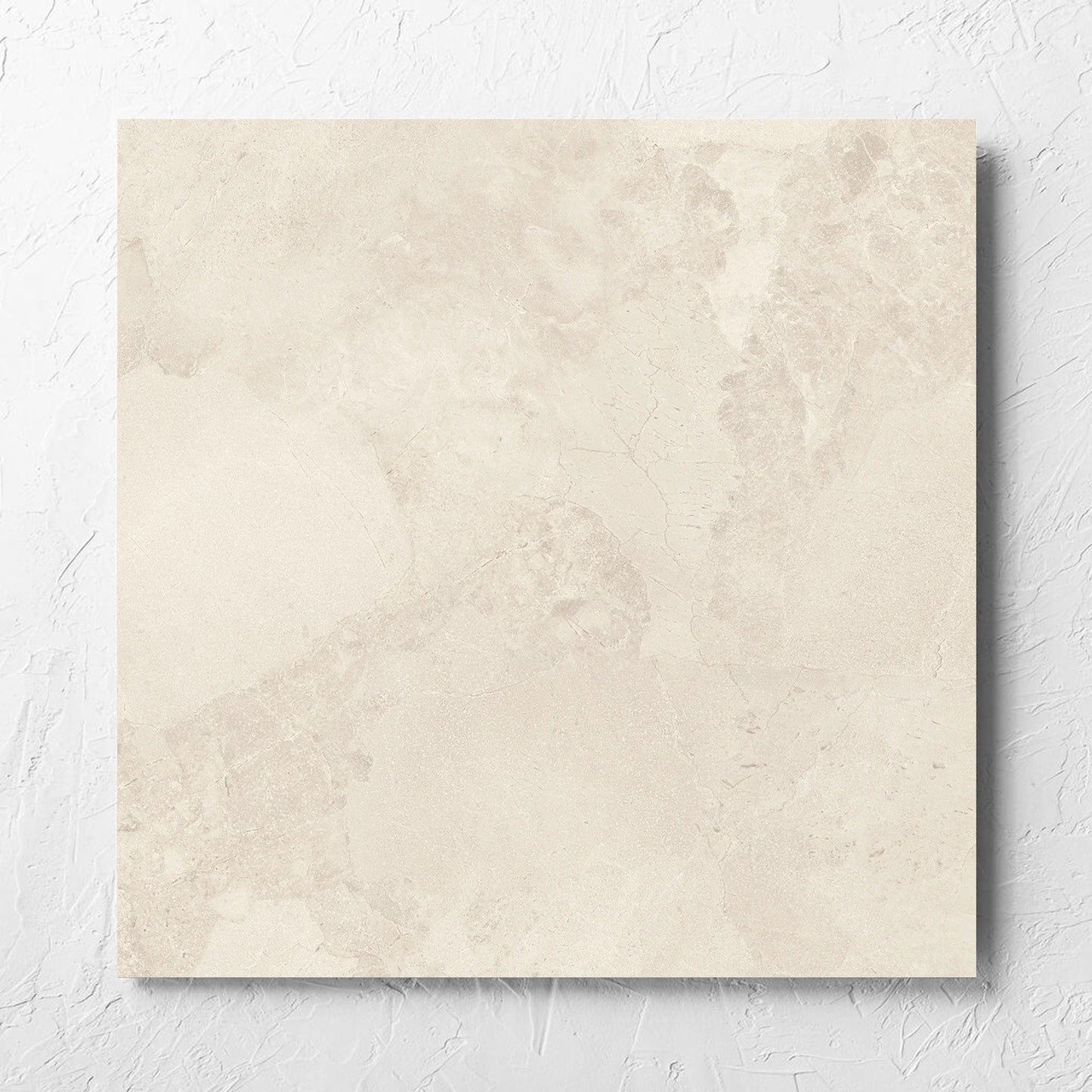 Aurelia Stone White Grip 600x600mm tile laid flat on a white rendered wall, showing the matt surface