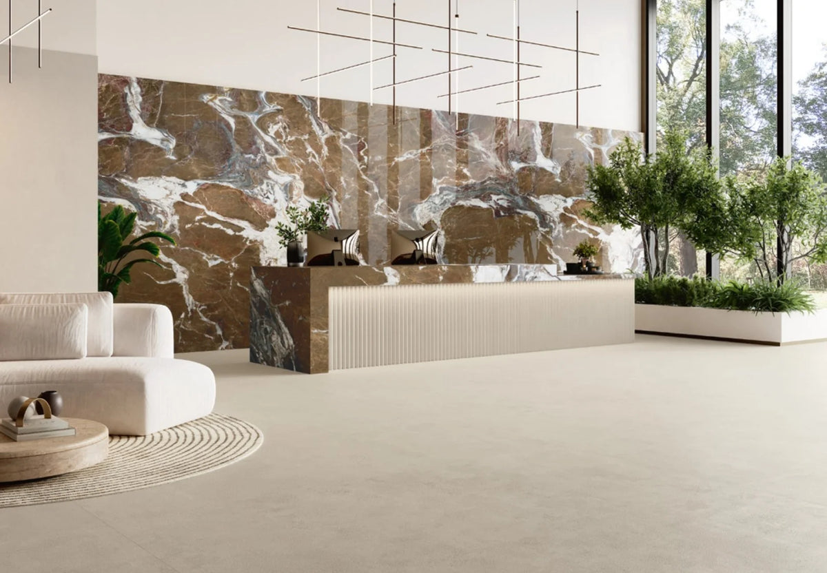 Balance Ivory Matt 600x1200mm large-format floor tiles installed in a luxury hotel lobby with a marble feature wall, fluted reception desk, and indoor greenery.
