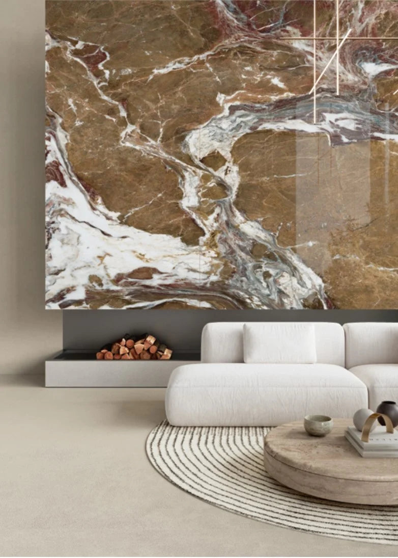 Balance Ivory Matt 600x1200mm tiles installed as a dramatic living room feature wall with rich brown and white marble veining above a modern fireplace and white sofa.