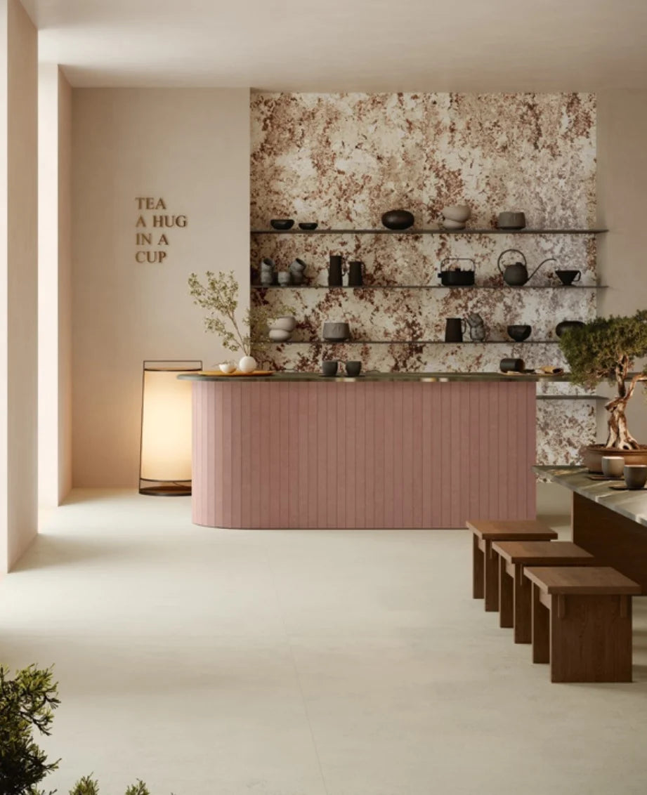Balance Ivory Matt 600x1200mm large-format floor tiles in a serene tea house interior featuring a pink ribbed counter, bonsai tree, and open shelving.