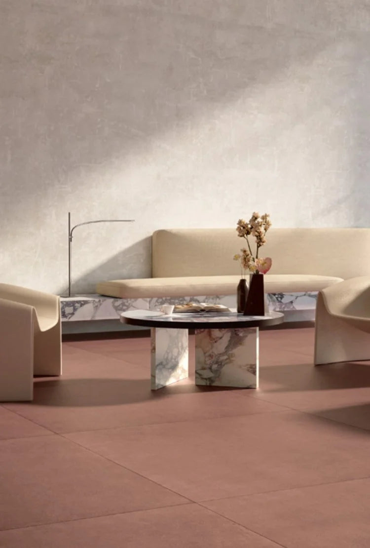 Balance Marsala Red 600x600mm tiles used as a warm terracotta floor in a minimalist living room styled with a marble coffee table and cream sofa.