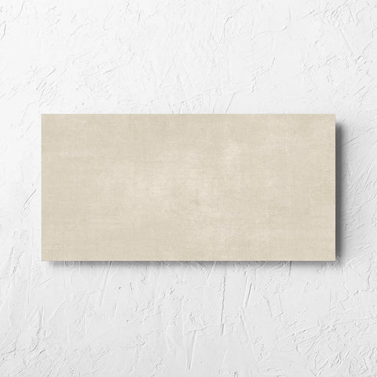 Bayside Sand Natural Matt 300x600mm tile laid flat on a white rendered wall, showing the matt surface