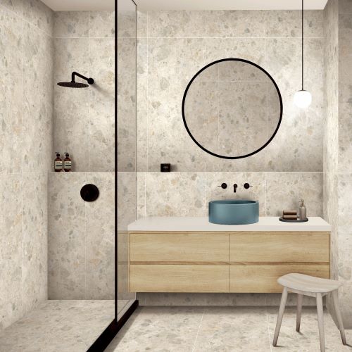 Bedrock Ivory Grip 600x600mm tiles covering bathroom walls and floor, paired with a timber vanity, teal vessel sink, and round pendant mirror.