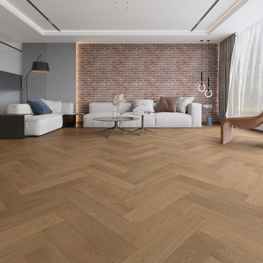 Beige Ash iDesign Herringbone Flooring 15/3mm installed in a modern living room with exposed brick wall, white sofas, and pendant lights.