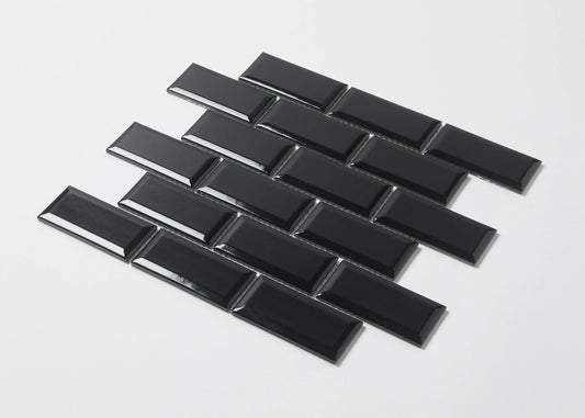 Pack shot of Black Gloss Glazed Porcelain Rectangle Bevelled Edge 45x95mm tiles arranged in a staggered brick pattern showing their high-gloss finish and bevelled profile.