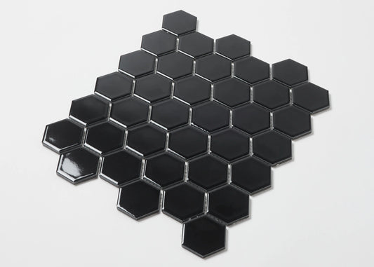 Pack shot of Black Gloss Porcelain Glazed Hexagon 51x59mm tiles arranged in a honeycomb mosaic sheet pattern against a white background.