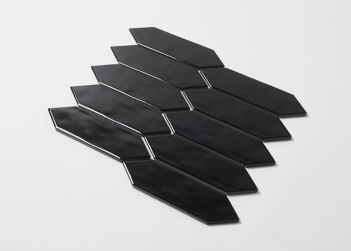 Pack shot of Black Gloss Porcelain Glazed Ripple Surface Arrow 55x195mm tiles arranged in a staggered diagonal fan pattern showing glossy black elongated arrow shapes.
