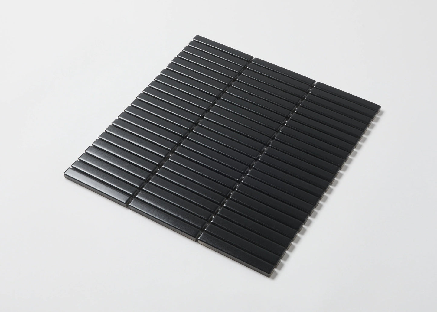 Pack shot of Black Matt Kitkat Straight Bone Pattern 12X92mm tiles arranged in a straight stacked layout, showcasing slim rectangular shapes and matte black finish.