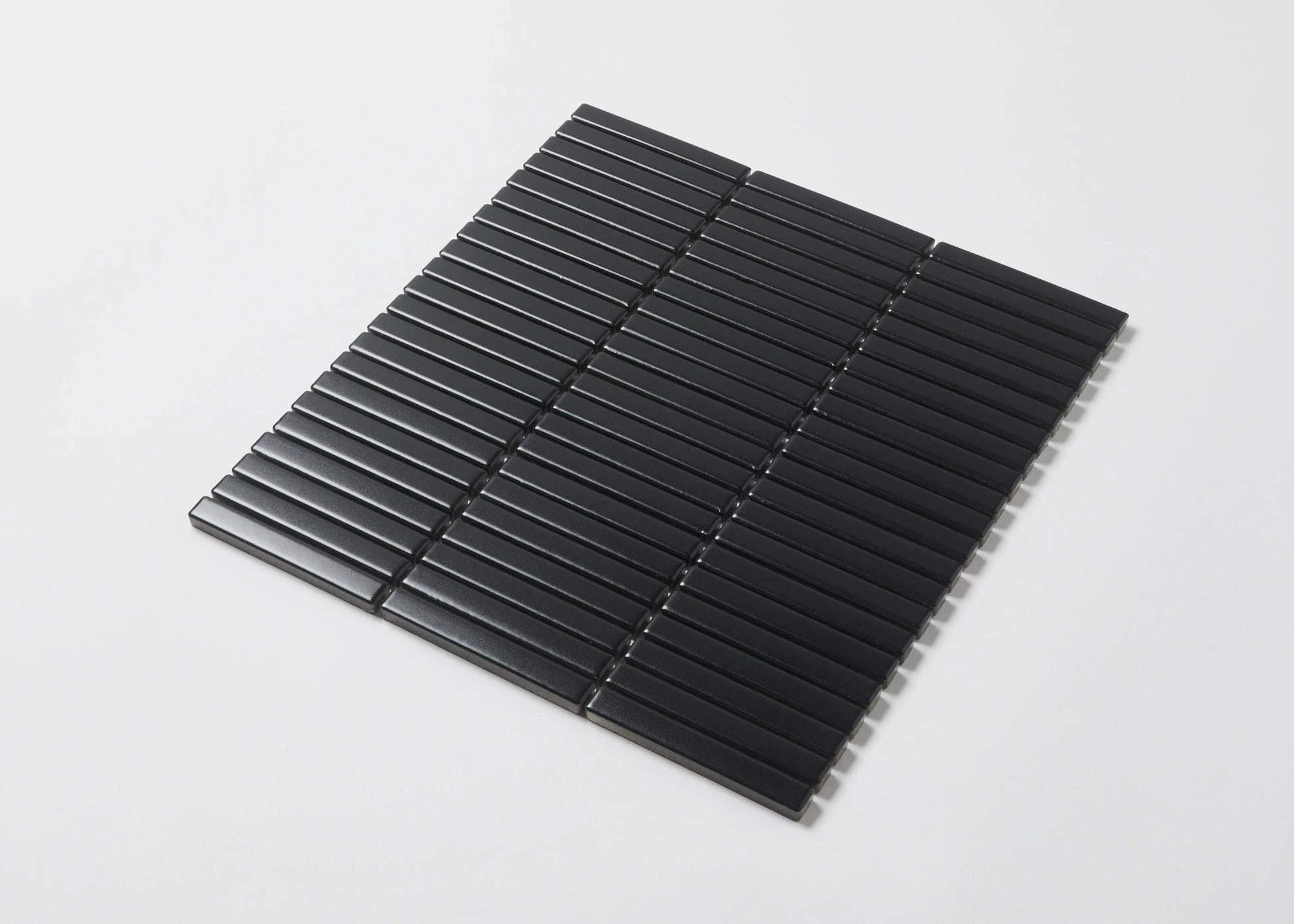 Pack shot of Black Matt Kitkat Straight Bone Pattern 12X92mm tiles arranged in a straight stacked layout, showcasing slim rectangular shapes and matte black finish.