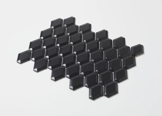Pack shot of Black Matte External Porcelain Glazed Honeycombe 46.5x60mm tiles arranged in a diamond cluster, showcasing their bevelled edges and matte black finish.