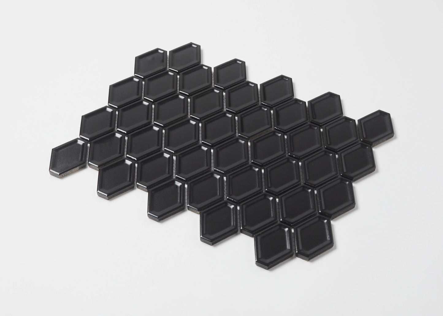 Pack shot of Black Matte Internal Porcelain Glazed Honeycombe 46.5x60mm tiles arranged in a honeycomb pattern, showing bevelled edges and matte black finish.