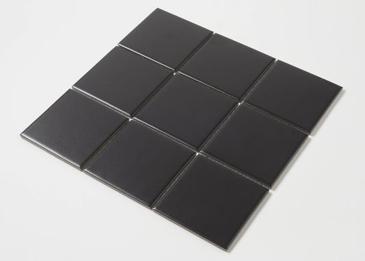 Nine Black Matte Porcelain Glazed 97x97mm Square tiles arranged in a 3x3 grid, showcasing the smooth matte black finish and square format.