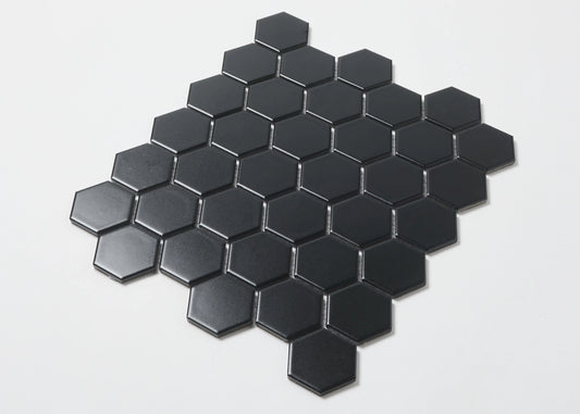 Pack shot of Black Matte Porcelain Glazed Hexagon 51x59mm tiles arranged in a diamond cluster pattern, showcasing the flat matte black finish and geometric hexagonal shape.