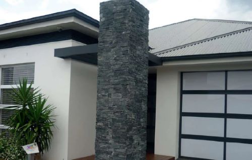 Black Mica Schist Z Panel Interlock 200x600mm cladding installed on a tall exterior feature column of a modern white rendered home with garage.