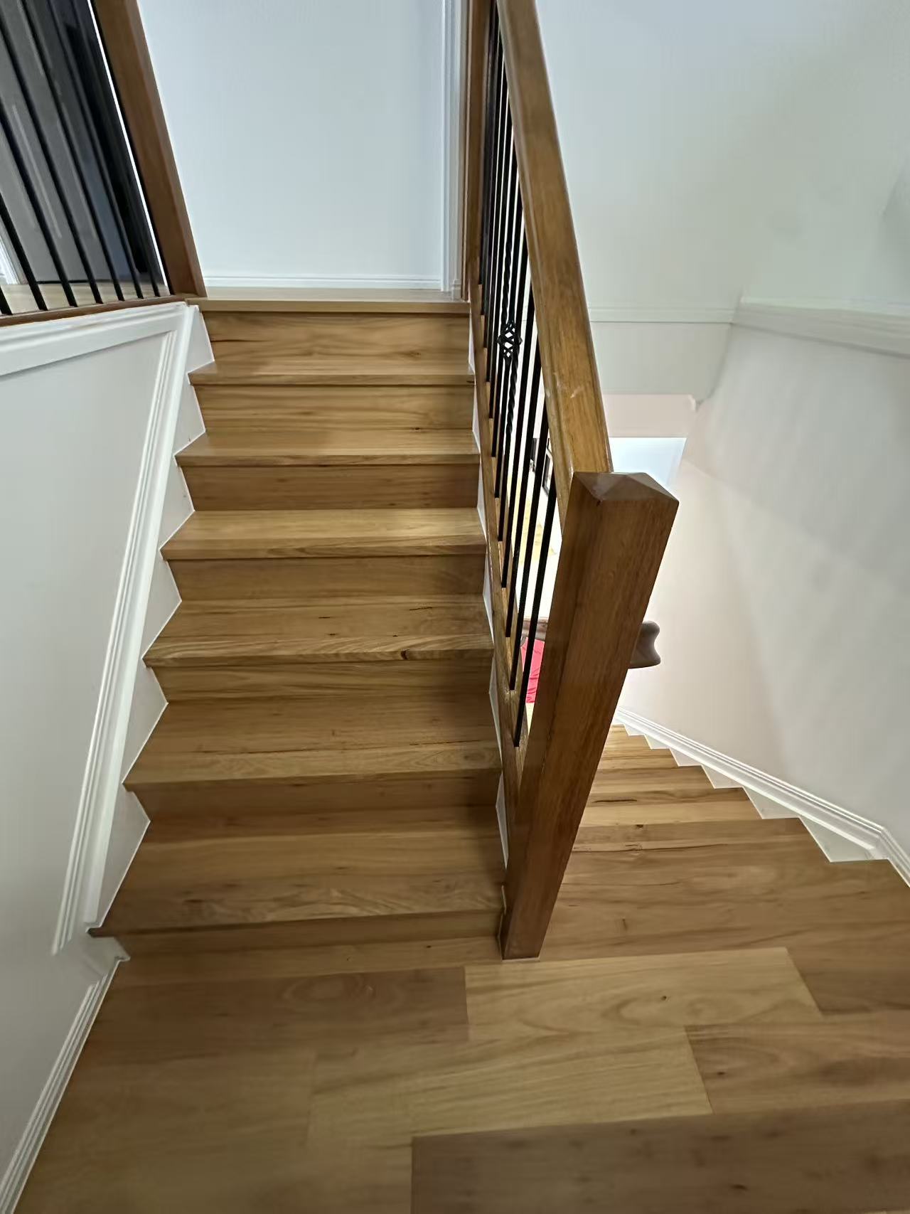 Blackbutt Engineered Australian Classic Flooring 14/3mm installed on a staircase with warm honey tones, timber handrail, and black iron balusters.