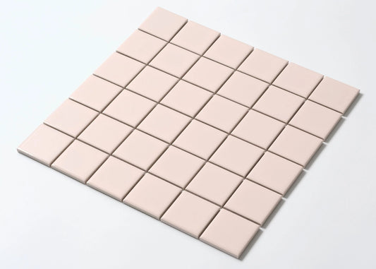 A mosaic sheet of Blush Gloss Porcelain Glazed 48x48mm Square tiles arranged in a 6x7 grid, showcasing their soft pink glazed finish and uniform square format.