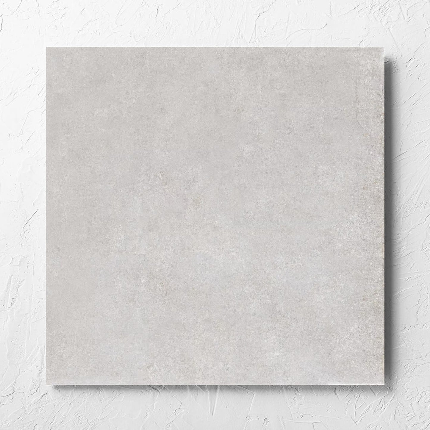 Boston Silver Matt 600x600mm tile laid flat on a white rendered wall, showing the tile surface