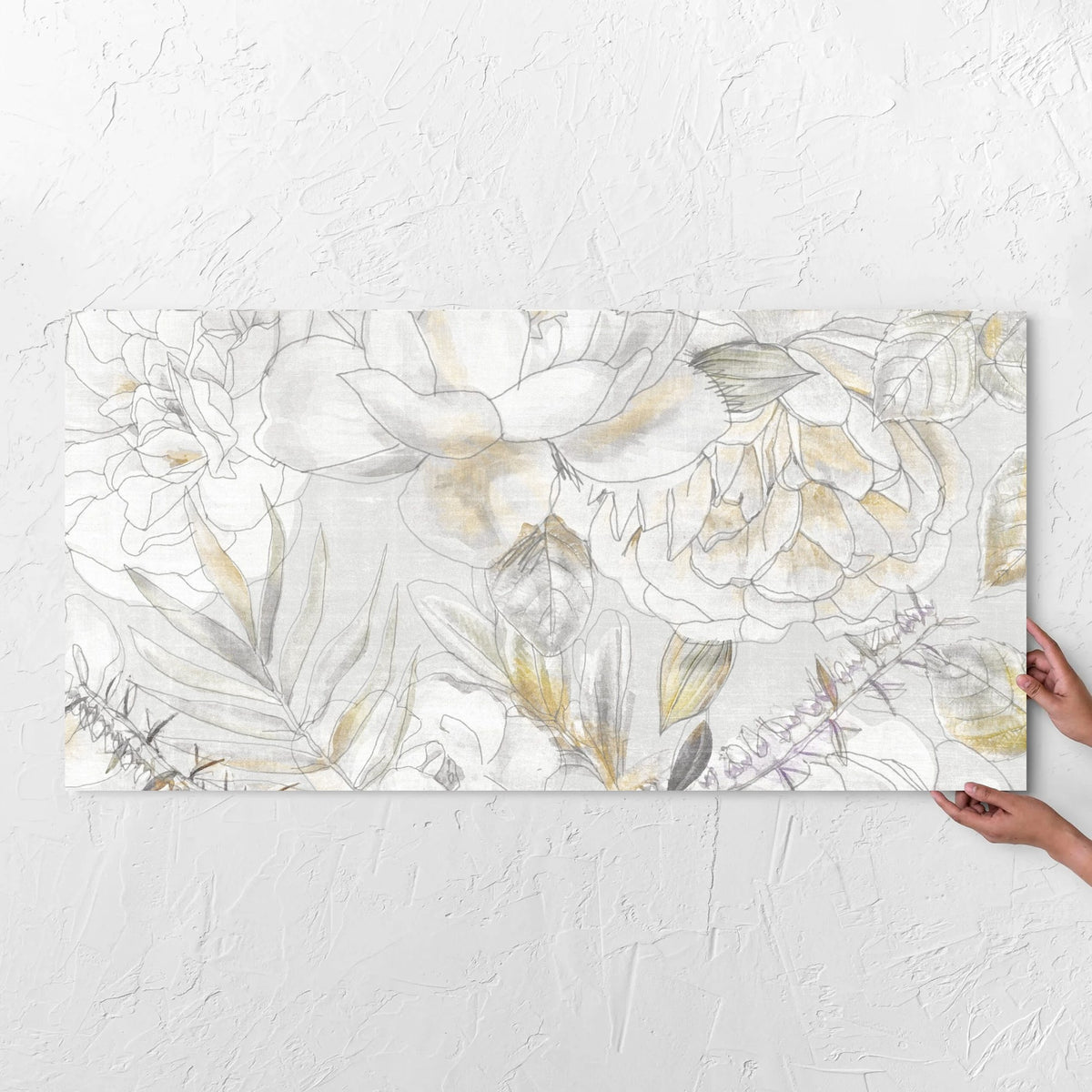 Hands holding a Botanica Magnolia Decor 600x1200mm tile against a white rendered wall, showing the matt surface