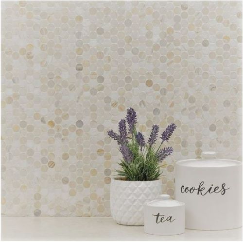 Boutique Calacatta Gold Mix Recycled Glass Penny Round 290x315mm installed as a kitchen splashback styled with a lavender plant, tea canister, and ceramic cookie jar.
