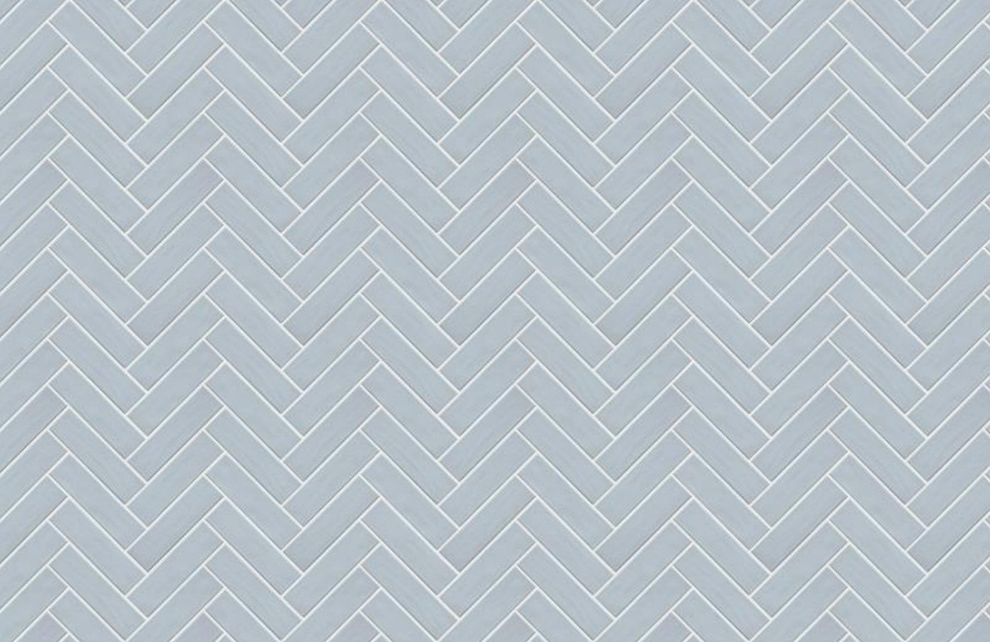 Brava Rustic Blue Gloss 60x217mm tiles arranged in a classic herringbone pattern, showcasing their pale blue gloss finish and precise rectangular shape.
