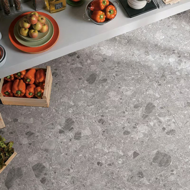 Breccia Mid Grey 600x600mm porcelain floor tiles installed in a modern kitchen with fresh produce, bell peppers, and a white countertop.