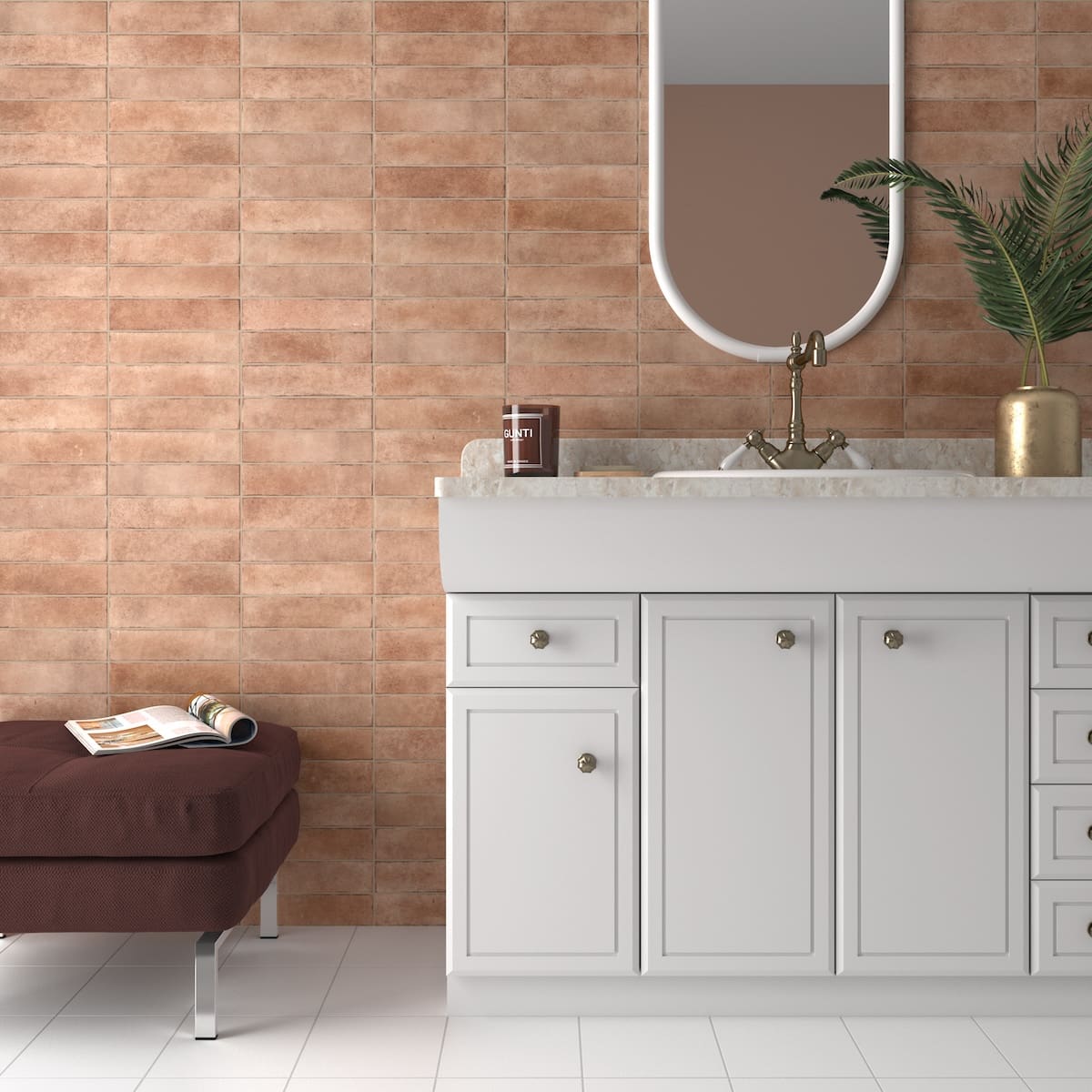 Bricks Cotto Matt 60x246mm terracotta wall tiles installed in a bathroom behind a white vanity unit with brass faucet and oval mirror.