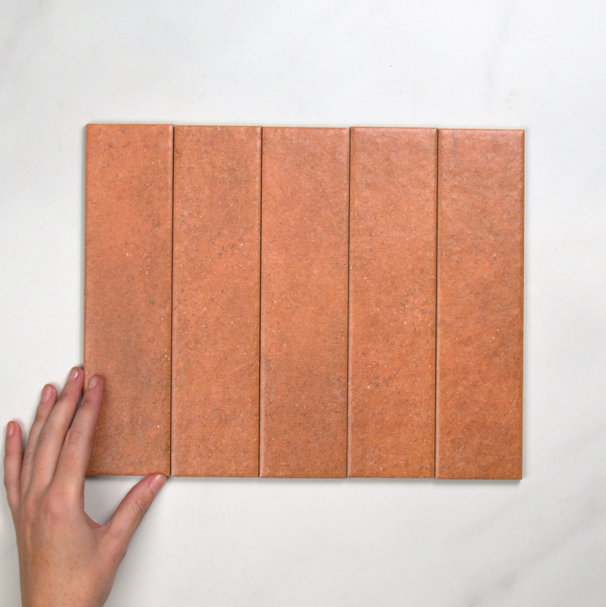 Brickworks Rosso Matt 60x240mm top view, hand for scale