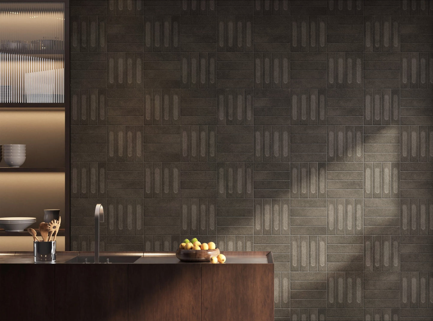 Brickworks Verde Matt Decor 60x240mm tiles installed as a dark moody kitchen feature wall behind a timber island bench with fruit bowl and sink.
