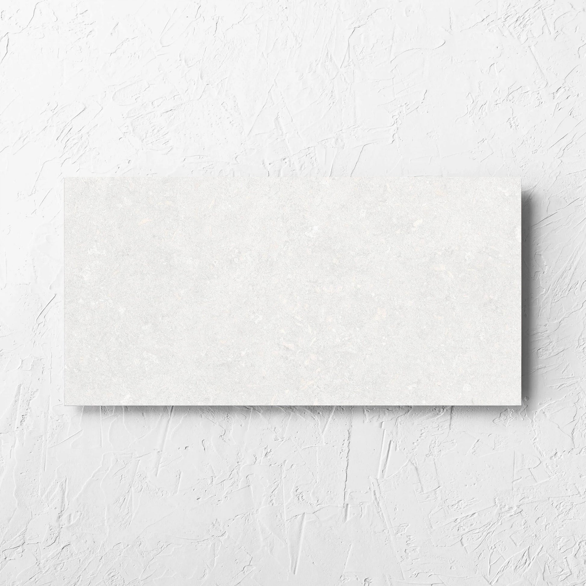 Brighton Bianco Matt 300x600mm tile laid flat on a white rendered wall, showing the matt surface