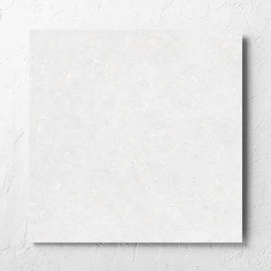Brighton Bianco Matt 600x600mm tile laid flat on a white rendered wall, showing the matt surface