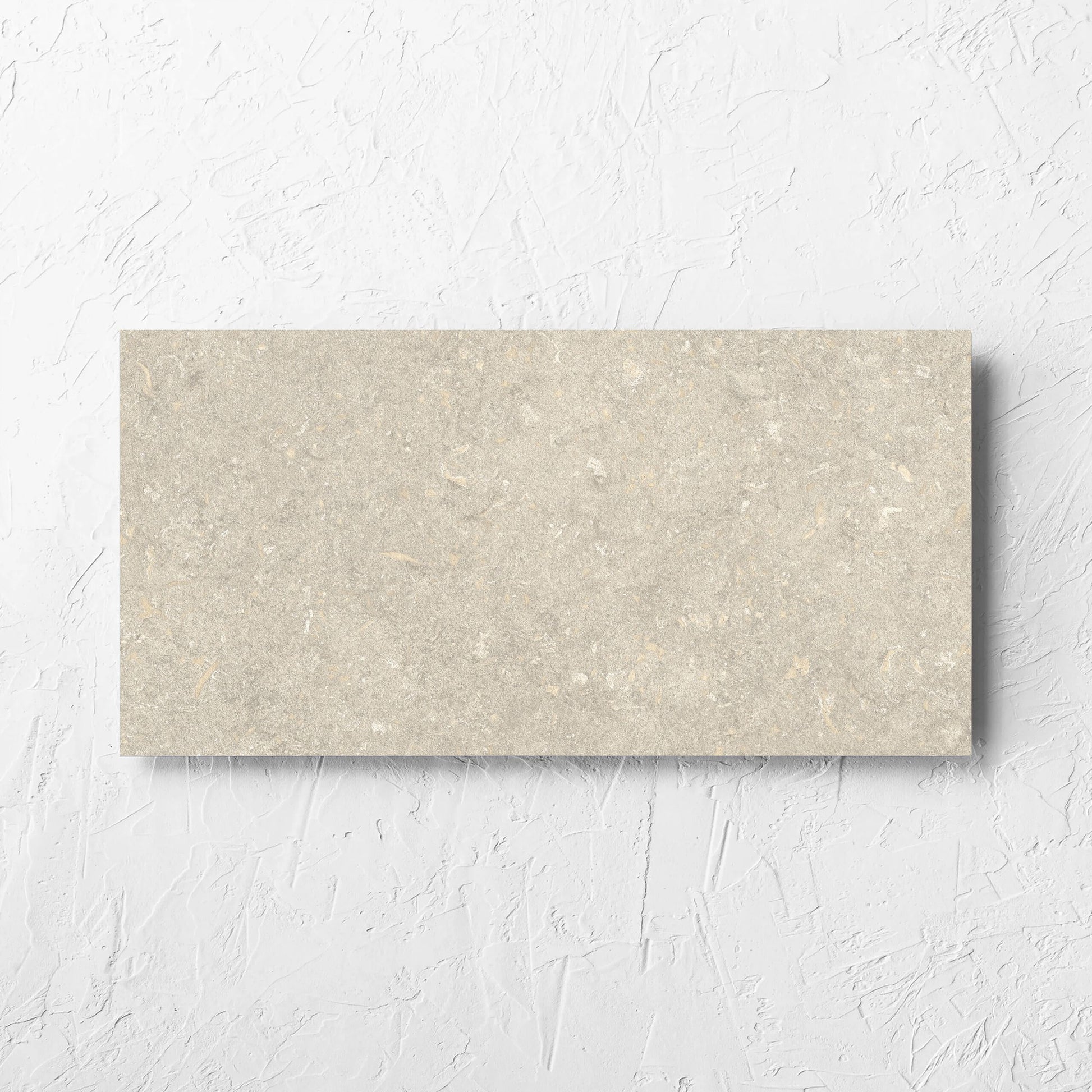 Brighton Earth Matt 300x600mm tile laid flat on a white rendered wall, showing the matt surface