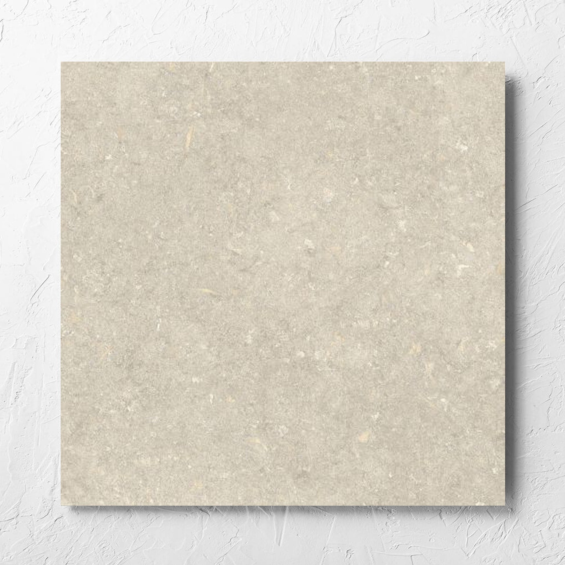Brighton Earth Matt 600x600mm tile laid flat on a white rendered wall, showing the matt surface