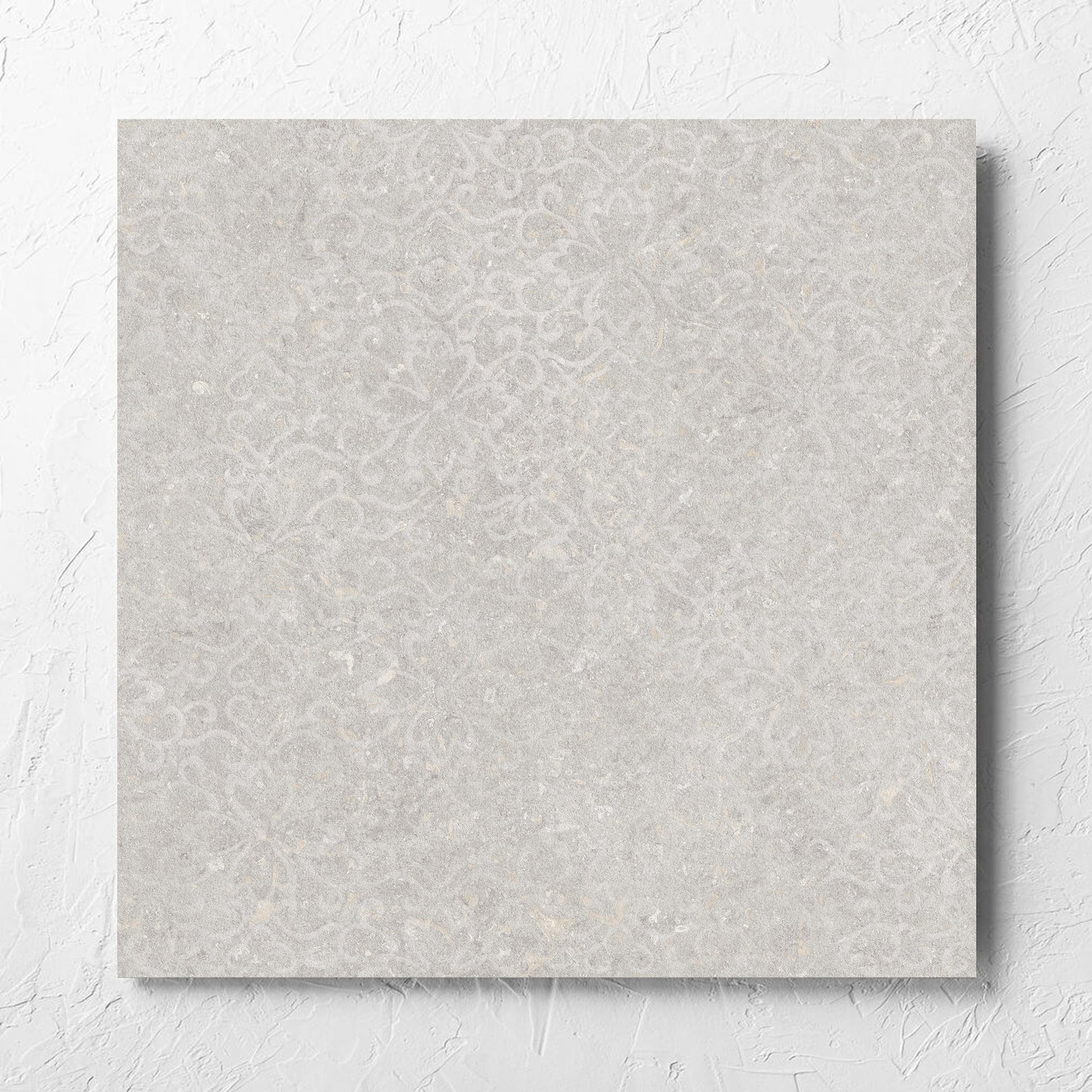 Brighton Stone Matt 600x600mm tile laid flat on a white rendered wall, showing the matt surface