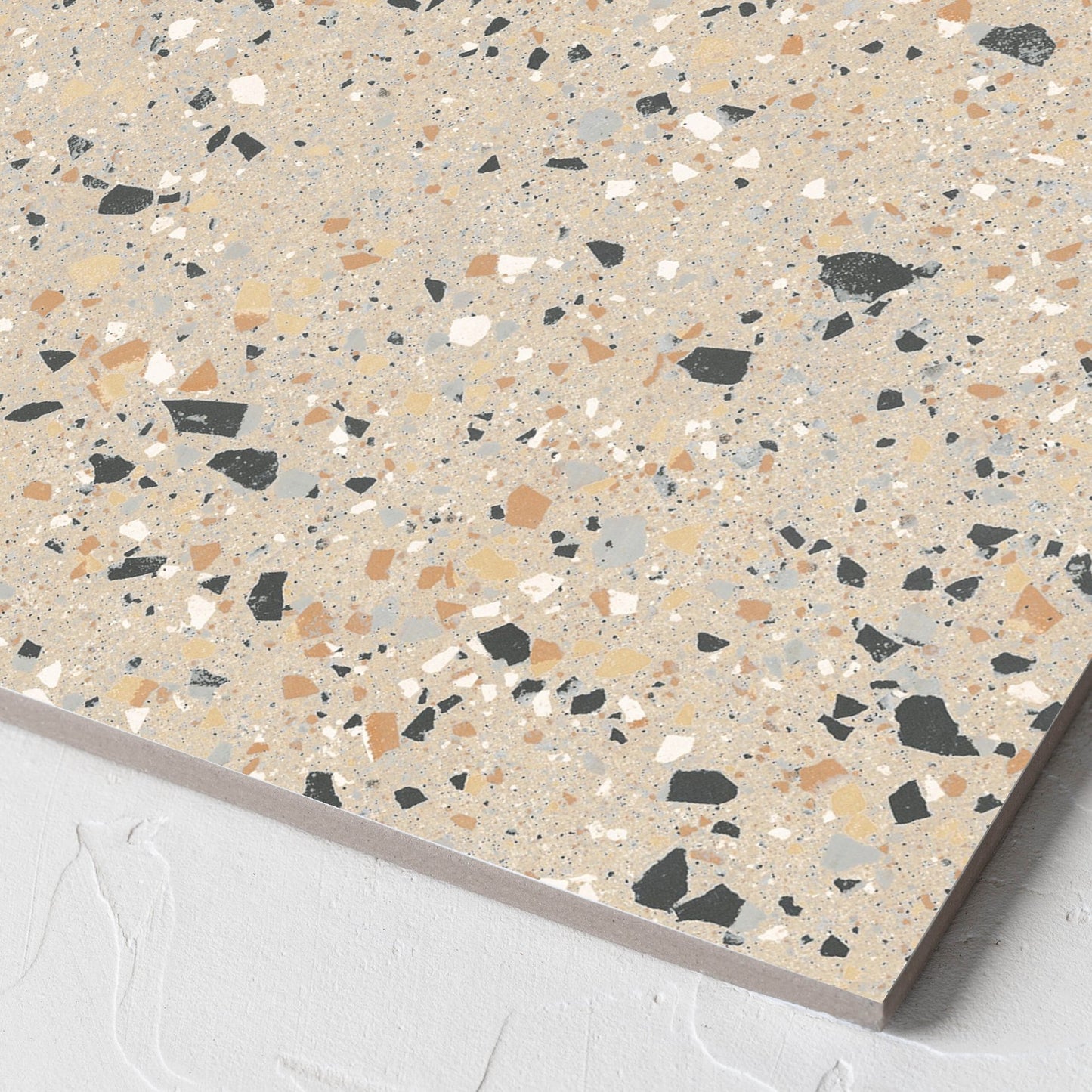 Corner close-up of the C Venice 300x300 Matt Beige Terrazzo Look Rectified tile showing the beige terrazzo look surface and the edge profile