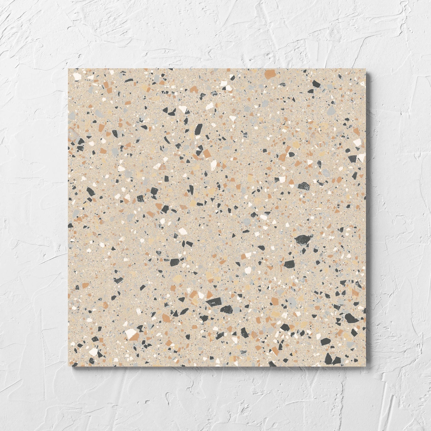 C Venice 300x300 Matt Beige Terrazzo Look Rectified tile laid flat on a white rendered wall, showing the beige terrazzo look surface
