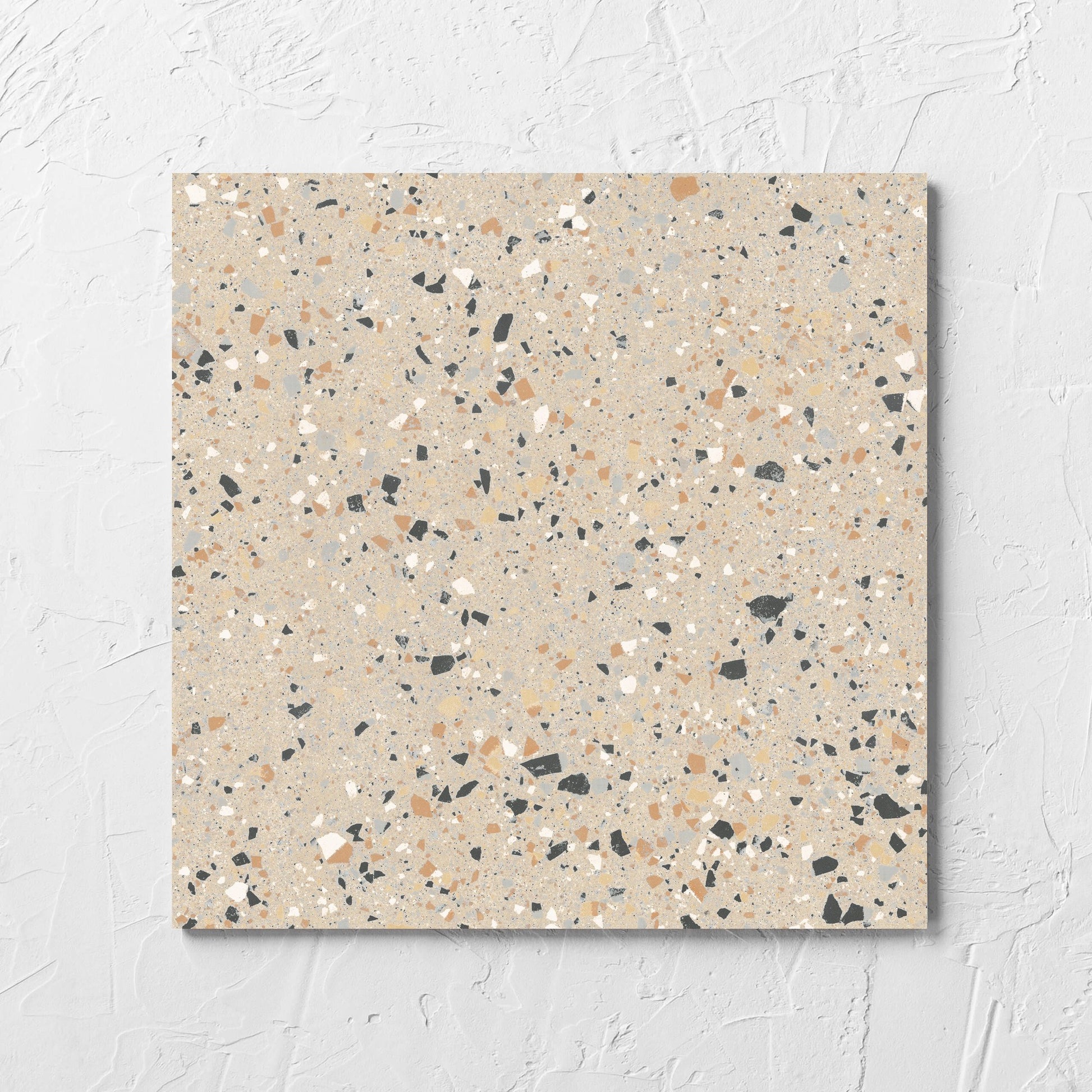 C Venice 300x300 Matt Beige Terrazzo Look Rectified tile laid flat on a white rendered wall, showing the beige terrazzo look surface